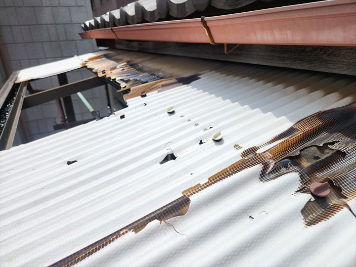 雹によって穴が空いたベランダの波板屋根